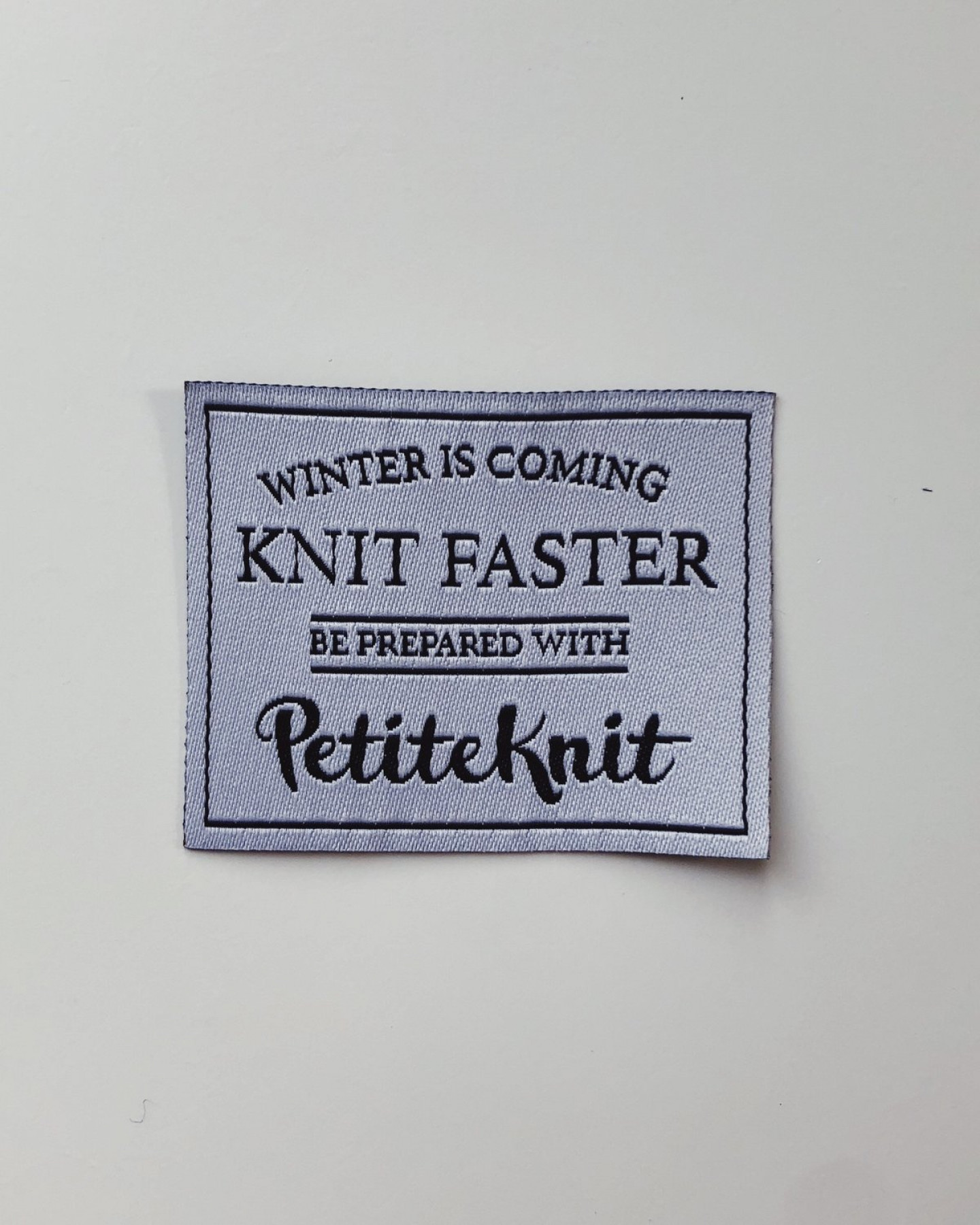 "Winter Is Coming - Knit Faster" by PetiteKnit -kangasmerkki